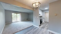 Located at 201 Rock Crystal Ln in Lakeside Park, Kentucky, this two-bedroom, three-bathroom residence offers a well-organized single-floor layout designed for comfortable everyday living. The combined kitchen and living area forms the heart of the home, with the kitchen featuring white cabinetry, granite-style countertops, stainless steel appliances including a refrigerator and dishwasher, and durable wood-look flooring that carries a clean, modern aesthetic. The spacious living room is carpeted and bathed in natural light through a sliding glass door that opens to an outdoor balcony, providing a bright and welcoming atmosphere. Both bedrooms are carpeted and finished in soft neutral gray tones, with the primary bedroom offering a generous footprint and ample closet space via a double sliding-door closet. The textured ceilings throughout add a classic residential character. The three bathrooms are finished consistently with wood-look flooring, neutral gray walls, and white fixtures; one includes a white vanity with a lighted mirror and brushed nickel hardware, while another features a full tub and shower surround with built-in shelving. A connecting hallway ties the layout together efficiently, completing this cohesive and move-in-ready home.
