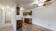 Located at 2610 Trojan Dr in Green Bay, Wisconsin, this one-bedroom, one-bathroom unit offers a functional and well-organized single-floor layout. The open-plan living, dining, and kitchen area forms the heart of the space, with wood-look hard flooring in the kitchen transitioning to plush carpet in the living and dining zones. A sliding glass door in the living room floods the area with natural light and leads directly to a private balcony, providing outdoor views of the surrounding neighborhood.

The galley-style kitchen is efficiently designed with rich dark wood cabinetry lining both walls, offering generous upper and lower storage. White appliances, including a range and refrigerator, complement the light countertops, while an under-cabinet range hood adds practicality.

The spacious bedroom features wall-to-wall carpet, a large window with an outdoor view, and baseboard heating. The room benefits from abundant natural light and includes access to closet storage. With four closets total throughout the unit, storage is a notable strength of this layout.

The bathroom is clean and straightforward, featuring a full tub-shower combination with a sliding glass door. A hallway connects the main living areas to the bedroom and bathroom, maintaining a clear and logical flow throughout the unit.