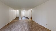 Located in North Portland, this one-bedroom, one-bathroom unit offers a practical and comfortable single-floor layout. The combined living and dining area is a highlight of the space, featuring plush carpeting, a textured ceiling, and a sliding glass door that floods the room with natural light and opens to a view of lush greenery — ideal for relaxing or entertaining. A structural column adds a subtle architectural detail to the open-concept area, while wood-style flooring defines the transition into the kitchen and hallway zones.

The kitchen is efficiently laid out and connects seamlessly to the main living area, complemented by a nearby hallway that provides access to the bedroom and bathroom. The bedroom is generously sized with soft carpeting, a window overlooking the outdoors, a baseboard heater, and two closets offering ample storage. The bathroom features wood-style flooring, a clean white tub/shower combo, and a bright, functional design. Three closets throughout the unit provide additional storage flexibility. The overall aesthetic is clean, neutral, and move-in ready.