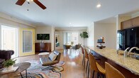 This two-floor home on Gardners Way in Enfield, Connecticut, offers a well-designed layout that balances open communal spaces with private retreats across both levels. The main level is defined by a seamlessly connected kitchen, living, and dining area finished with warm hardwood flooring throughout. The kitchen is equipped with rich wood cabinetry, granite countertops, black appliances, and a generously sized island with bar seating — an ideal centerpiece for both cooking and casual dining. Crown molding and recessed lighting add a polished touch to the open-concept space, which flows naturally into the dining area and living room. The living room features crown molding, a ceiling fan, and natural light from sliding glass doors that overlook an outdoor area. A second sitting area provides additional lounge space with hardwood floors and large windows.

The upper level hosts the bedrooms, each carpeted and finished with crown molding and ceiling fans. The primary bedroom includes natural light from a dedicated window, while additional bedrooms offer equally comfortable, versatile spaces. Bathrooms feature tile flooring, wood vanities, and glass-enclosed showers or tub-shower combinations. The attached garage provides convenient enclosed parking and interior access.
