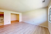 This 2-bedroom, 1-bathroom home in Sayreville, NJ offers a practical and well-organized single-floor layout. Throughout the living areas and bedrooms, light-toned wood-style flooring creates a clean, cohesive look, complemented by neutral cream-toned walls and crisp white baseboards that give the space a bright, fresh appearance.

The home features two living room areas, offering flexible options for a dedicated dining space or home office. The rooms are open and functional, with one flowing into the other through an open archway. The primary bedroom is generously sized, providing ample room for furniture arrangements, while the second bedroom offers a comfortable, well-lit space with a window bringing in natural light.

The kitchen is appointed with warm wood cabinetry, a mosaic tile backsplash with earthy tones, a gas range, dishwasher, and marble-style tile flooring, combining practicality with visual appeal.

The bathroom is a standout feature, finished with elegant marble-look tile covering both the floor and the tub surround. A window above the toilet allows for natural light and ventilation, enhancing the clean, polished feel of the space.

Overall, this home presents a move-in-ready interior with consistent, updated finishes throughout its well-proportioned floor plan.