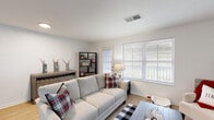 Located at 4015 Woodland Creek Dr SE in Kentwood, Michigan, this single-floor residence offers a well-organized and functional layout designed for comfortable everyday living. The open-concept living and dining area is bright and welcoming, featuring light-toned hardwood-style flooring, neutral walls, and large windows that allow natural light to fill the space. A door provides direct access to the outdoors, enhancing the connection to the surrounding environment. The dining area sits adjacent to the living room, creating a seamless flow ideal for both relaxing and entertaining. The kitchen is equipped with white cabinetry, light countertops, a stainless steel sink with a matte black faucet, and stainless steel appliances including a refrigerator and gas range. A pass-through counter with bar seating opens the kitchen to the main living space, improving visibility and interaction between rooms. A dedicated laundry area houses a stacked washer and dryer unit, adding practical in-unit convenience. The bedroom is a spacious and restful retreat with plush carpeting, a natural light window, and generous closet storage including a walk-in style closet with built-in shelving alongside an additional double-door closet. Overall, the home presents a clean, modern aesthetic with thoughtful functionality throughout.