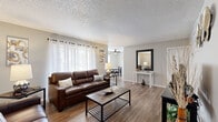 Located at 840 S Grand Hwy in Clermont, FL, this single-floor 2-bedroom, 1-bathroom home offers a functional and comfortable layout. The open-concept living and dining area is the heart of the home, featuring warm wood-look flooring, neutral gray walls, and a textured ceiling. Large windows with sheer curtains allow natural light to fill the living room, while a ceiling fan keeps the dining area bright and airy. The galley-style kitchen is efficiently designed with white cabinetry, white appliances, light countertops, and matching wood-look flooring, maximizing every inch of space. The primary bedroom is a comfortably sized retreat with warm lighting and hardwood-style flooring, while the second bedroom accommodates two beds and features colorful accents, making it ideal for guests or shared use. Both bedrooms benefit from dedicated closet space, including a generously sized walk-in closet with built-in shelving. The shared bathroom features a white vanity with a mirrored cabinet, wood-look flooring, and a bathtub. Throughout the home, consistent flooring, neutral tones, and clean finishes contribute to a cohesive and inviting ambiance.