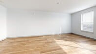 Located at 1184 Hank Aaron Dr in Atlanta, Georgia, this efficiently designed single-floor unit offers a clean, modern aesthetic throughout. The open-plan kitchen and living area serves as the heart of the space, characterized by light hardwood flooring that extends seamlessly across the main areas. The kitchen is well-appointed with crisp white cabinetry extending to the ceiling, stainless steel appliances including a refrigerator, electric range, microwave, and dishwasher, along with a double-basin sink and ample counter space. Natural light filters in through multiple windows fitted with horizontal blinds, illuminating the living area and creating a bright, airy atmosphere with views of the surrounding Atlanta cityscape. The entrance leads conveniently into the main living space, with a dedicated closet providing practical storage. A utility room and in-unit laundry add everyday convenience. The bathroom features a full soaking tub and shower combination with large-format tile surround, grab bars, and dark hardwood-style flooring, offering a clean and functional design. Throughout the unit, neutral white walls and consistent light-toned flooring contribute to a cohesive, contemporary feel that maximizes the sense of openness within the compact footprint.