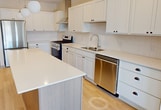 This contemporary 1000 square foot apartment in Victoria, MN, offers a harmonious blend of comfort and functionality. The open-concept floor plan creates a spacious feel, with the living area seamlessly connecting to the gourmet kitchen. The kitchen is a highlight, boasting white cabinetry, stainless steel appliances, and a large center island with a sleek quartz countertop, perfect for meal preparation or casual dining.

The two bedrooms are generously sized, with the primary bedroom measuring 170 square feet. Both bathrooms feature modern fixtures, including vanities with ample storage and combination tub-showers. The in-unit laundry room adds convenience, equipped with a washer and dryer set.

Storage is abundant throughout, with walk-in closets in the bedrooms and additional closet space in the common areas. The apartment's design prioritizes natural light, with large windows in the bedrooms and living areas. Flooring varies between rooms, with warm wood-look floors in the main living areas and plush carpeting in the bedrooms.

The neutral color palette and clean lines create a fresh, contemporary ambiance that serves as a blank canvas for personal style. This well-designed apartment offers a perfect balance of style and practicality for modern living.