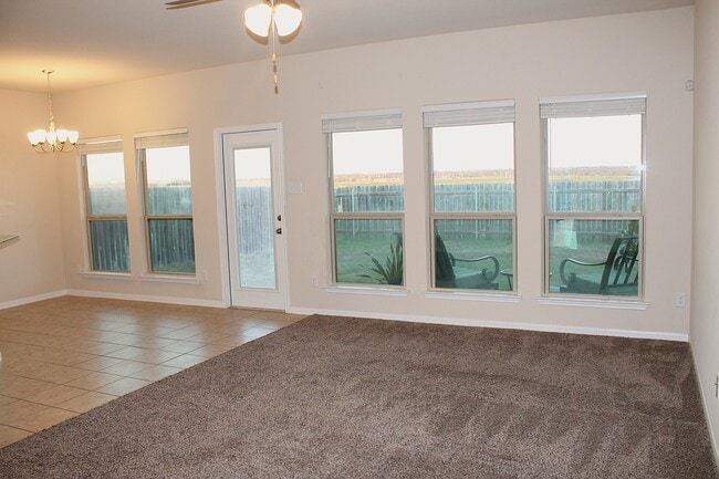Sun pour living and dining room with east facing windows. - 1027 Aurora Grove Bnd