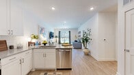 Located in Atlanta's vibrant Grant Park neighborhood, this one-bedroom, one-bathroom residence offers a thoughtfully designed single-floor layout with modern finishes throughout. Light wood-tone flooring flows through the open-concept living and kitchen areas, creating a warm, cohesive aesthetic.

The living room is bright and inviting, featuring a sliding glass door that opens to a private balcony with outdoor views of lush greenery, allowing natural light to fill the space. The kitchen is well-appointed with white shaker cabinetry, granite countertops, a classic subway tile backsplash, and a full suite of stainless steel appliances, including a side-by-side refrigerator, electric range with over-the-range microwave, and ample storage.

The bedroom is a comfortable retreat with plush carpet, a ceiling fan, natural light from a window with blinds and curtains, and access to a closet. The bathroom features wood-look flooring and clean, neutral finishes, with an open sightline into the bedroom for an airy feel.

A dedicated laundry room houses a full-size washer and dryer with built-in shelving for added storage convenience. The space combines functional design with a modern, livable atmosphere ideal for everyday comfort.