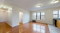 Located at 2 Osborne Terrace in Newark, NJ, this 2-bedroom, 1-bathroom residence offers a practical and well-maintained living space across a single floor. Polished hardwood floors flow throughout the unit, adding warmth and a classic character to each room. The open living area is bright and airy, anchored by large black-framed windows that draw in natural light and offer views of the surrounding neighborhood. A classic cast-iron radiator provides reliable heating. The kitchen features warm wood cabinetry, a stainless steel refrigerator, and a gas range, with tile flooring that transitions seamlessly from the living area. Both bedrooms are generously proportioned with hardwood floors, natural light from windows with street views, and individual radiators. The primary bedroom is a comfortable size suited for a full furniture arrangement. The bathroom is finished with neutral beige tile surrounding a full soaking tub and shower, complemented by a white vanity with ample storage and a window for ventilation. Two hallway spaces provide practical transitional areas throughout the unit. Overall, the residence presents a clean, straightforward layout well-suited for comfortable urban living in Newark.