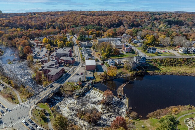 The historic downtown in Putnam sits right along the river and is surrounded by trees.