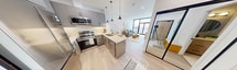 This efficiently designed 470 square foot apartment maximizes space and style in its one-bedroom, one-bathroom layout. The open-concept floor plan seamlessly integrates the living room, kitchen, and dining area, creating a sense of spaciousness. The living room boasts floor-to-ceiling windows that flood the space with natural light and offer stunning city views. A contemporary grey sofa, accent chairs, and a modern coffee table define the seating area, complemented by a large abstract art piece.

The kitchen features sleek grey cabinetry, stainless steel appliances, and a quartz countertop with a breakfast bar. Pendant lighting adds a touch of elegance to the space. The 110 square foot bedroom includes a comfortable queen-sized bed and built-in storage solutions. Large windows continue the bright, airy feel of the apartment.

The bathroom showcases a modern design with a tiled shower/tub combination and a stylish curtain. Throughout the apartment, light wood flooring enhances the contemporary aesthetic. Smart storage solutions and minimalist decor maintain a clutter-free environment, making this compact space feel larger than its actual square footage. Located at 100 Fullarton Street in London, ON, this apartment offers a perfect blend of style and functionality for urban living.