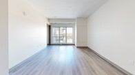 Located at 835 W Broadway Ave in Minneapolis, MN, this 2-bedroom, 1-bathroom unit offers a thoughtfully designed, single-floor layout with contemporary finishes throughout. The open-concept kitchen and living area serves as the heart of the home, featuring light wood laminate flooring that flows seamlessly through the main living spaces. The kitchen is well-appointed with light wood cabinetry, granite-style countertops, a double-basin sink, and a full suite of stainless steel appliances including a refrigerator, range, over-the-range microwave, and dishwasher. The living room benefits from large floor-to-ceiling windows and a glass sliding door that fills the space with natural light and frames views of the surrounding Minneapolis skyline. Both bedrooms are carpeted and offer a quiet, comfortable retreat; the primary bedroom is generously sized and features a window with outdoor views, while the second bedroom is well-proportioned with its own window. The full bathroom includes a shower/tub combination and a vanity with ample counter space. Neutral wall tones, clean lines, and modern hardware and fixtures give the unit a fresh, move-in-ready aesthetic throughout.
