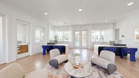 This well-appointed community amenity building offers a thoughtfully designed layout across its main floor, combining social and wellness spaces in a bright, contemporary setting. The living room serves as the heart of the space, featuring light hardwood flooring, recessed lighting, and an abundance of natural light streaming through large windows and glass double doors. Modern, curved lounge chairs in neutral tones are paired with bold navy blue accent seating, centered around a round marble-top coffee table atop a vibrant area rug. Built-in cabinetry with gray-toned finishes lines the walls, while curated artwork adds a refined touch to the crisp white walls. French doors lead directly to the outdoor area, where a resort-style pool is surrounded by white lounge chairs, artificial turf, and Adirondack seating, all set against a backdrop of mature trees. The exercise room is generously sized with rubber flooring and garage-style doors that open to the outdoors, fostering an airy workout environment. It is outfitted with treadmills, a cable weight machine, benches, free weights, and a variety of fitness accessories including stability balls and resistance equipment. Mirrors and recessed lighting complete the functional yet polished fitness space.