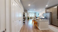 This 1-bedroom, 1-bathroom residence is thoughtfully designed to maximize both function and comfort across a single floor. The open-concept layout connects the kitchen and living room seamlessly, creating an inviting, continuous flow throughout the main living area. Light wood-style flooring runs throughout, lending warmth and visual continuity to the space.

The kitchen is well-equipped with rich, dark wood shaker-style cabinetry, granite countertops, a classic white subway tile backsplash, and stainless steel appliances including a range, microwave, and refrigerator. A peninsula with bar seating provides additional prep space and casual dining.

The living room benefits from a ceiling fan, large windows with sheer curtains, and ample natural light, creating a relaxed yet polished atmosphere. A dedicated closet with built-in shelving is conveniently accessible from the main hallway.

The bedroom is a comfortable retreat featuring natural light from a large window, wood-style flooring, and direct access to the bathroom and an expansive walk-in closet outfitted with multi-level wire shelving and hanging rods, offering generous storage capacity.

The full bathroom features a granite-topped vanity with dark cabinetry, a full soaking tub with white subway tile surround, and clean, neutral finishes throughout.