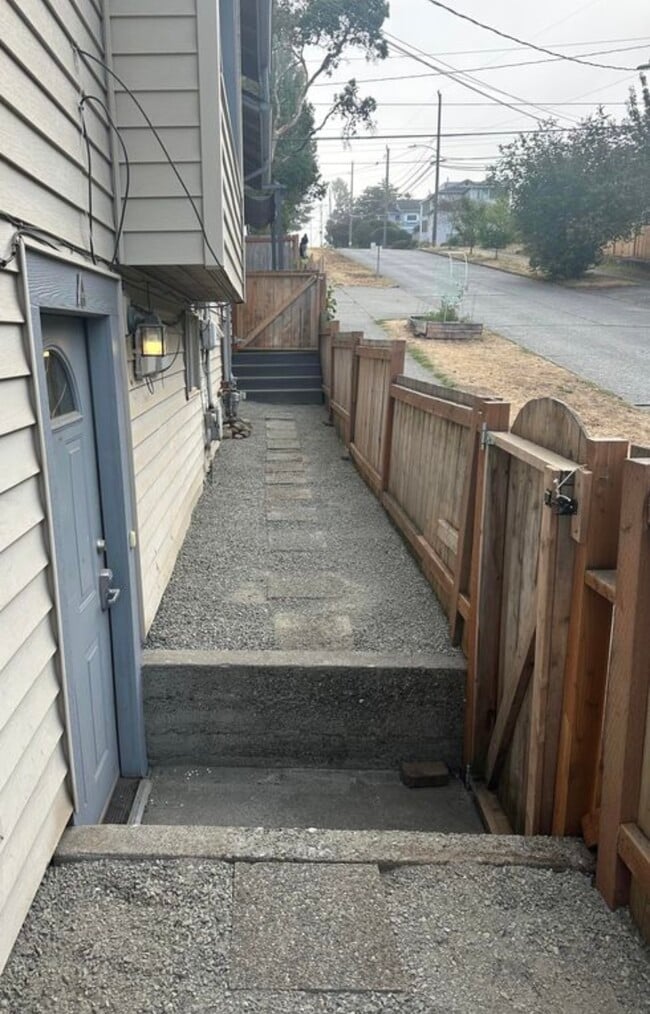 Entrance and side yard, fenced - 4158 46th Ave SW