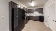 Located at 1090 German School Rd in Richmond, Virginia, this single-floor residence offers a thoughtfully designed layout with a clean, contemporary aesthetic. The space is finished with neutral tones throughout, creating a bright and welcoming atmosphere.

The kitchen is a functional highlight, featuring dark espresso-stained cabinetry with sleek hardware, light granite-style countertops, and a full suite of black appliances including a refrigerator, range, and dishwasher. Light wood-look flooring ties the kitchen together and extends into adjacent areas, providing a cohesive flow.

Multiple carpeted rooms offer comfortable, versatile living spaces. Each room benefits from natural light streaming through windows fitted with horizontal blinds, providing views of the surrounding neighborhood and greenery. The rooms feature neutral wall tones and clean white trim, lending a fresh and move-in-ready feel.

The bathrooms are finished with light wood-look flooring, granite-topped dark vanities, and full tub-shower combinations with curved shower rods. The clean, minimal design keeps the bathrooms feeling open and functional.

Overall, this residence presents a consistent and practical design language, with durable finishes, ample natural light, and a well-organized floor plan suited for comfortable everyday living in the Richmond, VA area.