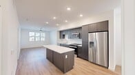 Located at 36101 Inland Valley Drive in Wildomar, CA, this single-floor 2-bedroom, 2-bathroom residence offers a thoughtfully designed open-concept layout. Light wood-style flooring flows consistently throughout the home, creating a bright, cohesive aesthetic.

The kitchen is a standout feature, showcasing dark espresso cabinetry that extends to the ceiling for generous storage, white quartz countertops, a subway tile backsplash, and a full suite of stainless steel appliances including a gas range, microwave, dishwasher, and a French door refrigerator with an in-door water and ice dispenser. A central kitchen island provides additional prep space and serves as a natural gathering point that opens directly into the living area. Recessed lighting and a ceiling fan enhance both the kitchen and living room.

The primary bedroom is a well-proportioned retreat featuring a ceiling fan, natural light from a window, and access to a dedicated walk-in closet with built-in shelving and hanging rods. The second bedroom is clean and versatile. Both bathrooms are finished with dark cabinetry, white quartz countertops, and tub-shower combinations with white tile surrounds. Two closets throughout the home provide ample storage for residents.