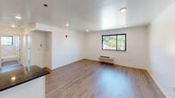 Located in the Roxborough neighborhood of Philadelphia, this single-floor unit at 461 Parker Ave offers a clean, contemporary living experience with thoughtfully updated finishes throughout. The open living area is bright and welcoming, featuring light hardwood-style flooring, recessed lighting, and a large window that frames views of the surrounding greenery. A wall-mounted HVAC unit ensures year-round comfort.

The kitchen is well-appointed with white shaker-style cabinetry, dark granite countertops, a classic subway tile backsplash, and a full suite of stainless steel appliances including a range, over-the-range microwave, refrigerator, and dishwasher.

The bedrooms continue the home's clean aesthetic, each featuring hardwood-style flooring, bright white walls, and multiple windows with views of the neighborhood's tree-lined surroundings. Individual HVAC units in each room provide personalized climate control.

The unit includes two bathrooms, each finished with marble-style tile. One features a sleek glass-enclosed walk-in shower, while the other offers a tub/shower combination with a window allowing natural light in. Both bathrooms are equipped with modern vanities and contemporary fixtures, completing this well-designed and move-in-ready space.