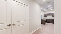 Located at 1590 Agape Way in Decatur, Georgia, this single-story 2-bedroom, 1-bathroom home offers a thoughtfully designed layout with contemporary finishes throughout. Light-toned luxury vinyl plank flooring flows seamlessly across the entire space, lending a clean, cohesive aesthetic to every room.

The open kitchen serves as a focal point, featuring rich dark-stained cabinetry, granite countertops, a large central island ideal for meal prep or casual dining, and a full suite of black and stainless steel appliances including a refrigerator, range, built-in microwave, and dishwasher. Recessed lighting illuminates the kitchen with a bright, functional ambiance.

The living room is generously sized and filled with natural light from large windows and a glass-panel exterior door, offering views of the surrounding neighborhood. A ceiling fan adds comfort to the space.

Both bedrooms are well-proportioned, each outfitted with ceiling fans, windows with blinds, and neutral warm-toned walls. The primary bedroom includes access to a dedicated closet with wire shelving systems, providing organized storage. A second closet offers additional storage capacity.

The bathroom is finished with large-format tile flooring, a granite-topped vanity with dark cabinetry, and a glass-enclosed walk-in shower with a built-in bench, delivering a clean, modern feel.