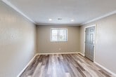 Located at 2473 Ladley Ct in Springfield, IL, this single-floor, one-bedroom, one-bathroom unit offers a practical and well-designed layout. The open-concept kitchen and living area serves as the heart of the home, featuring wood-look flooring, crown molding, and a textured ceiling throughout. The kitchen is equipped with stainless steel appliances—including a range, microwave, dishwasher, and refrigerator—complemented by crisp white shaker-style cabinetry and granite-style countertops, providing ample prep and storage space. The living area flows seamlessly from the kitchen, creating an airy, connected feel. The bedroom is a comfortable, well-proportioned space bathed in natural light from a window overlooking the exterior. It features the same wood-look flooring and neutral taupe wall tones found throughout the unit, along with recessed lighting and access to two closets for generous storage. The bathroom is clean and functional, offering a full tub-shower combination, a white vanity, and consistent flooring that ties the space together. Neutral gray and taupe tones, white trim, and consistent flooring create a cohesive, modern aesthetic throughout the entire unit.