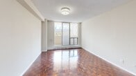 Located at 545 Sherbourne St in Toronto's vibrant St. James Town neighbourhood, this one-bedroom, one-bathroom unit offers a well-organized layout across a single floor. Rich, polished parquet hardwood flooring runs throughout the main living areas and bedroom, lending warmth and a classic character to the space.

The living room is bright and open, benefiting from large floor-to-ceiling windows that invite generous natural light and provide access to a private balcony with outdoor views of the surrounding cityscape. The bedroom is a comfortable, well-proportioned room featuring its own window with a notable view of the Toronto skyline, along with baseboard heating and the same distinctive parquet flooring.

The kitchen is functionally designed with white cabinetry, marble-style countertops, a tiled backsplash, stainless steel range, and light ceramic tile flooring — offering a clean, practical workspace. The bathroom is finished in crisp white tile, featuring a full soaker tub with an overhead shower, maintaining a clean and simple aesthetic throughout.

Textured ceilings are consistent across the unit, and neutral wall tones complement the warm tones of the hardwood floors. The thoughtful layout makes efficient use of the available space, offering a comfortable and functional home in a well-connected Toronto location.