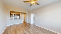 Located at 5220 Center St in Williamsburg, VA, this well-appointed one-bedroom, one-bathroom residence offers a thoughtfully designed single-floor layout. The open-concept living and kitchen area serves as the heart of the home, featuring light-toned hardwood-style flooring, neutral walls, and a ceiling fan that enhances airflow throughout. The kitchen is outfitted with rich dark cabinetry, granite countertops, a peninsula island with an undermount sink, pendant lighting, and a full suite of stainless steel appliances including a refrigerator, range, microwave, and dishwasher. A subway tile backsplash adds a clean, modern touch. The spacious bedroom offers plush carpeting, a ceiling fan, a large window with neighborhood views, and two closets for ample storage. The bathroom continues the upscale aesthetic with granite countertops, dark cabinetry, an undermount vanity sink, and a full tub-shower combination with tiled surround. Hardwood-style flooring extends throughout the main living areas. A dedicated laundry area adds everyday convenience. The overall ambiance is clean, modern, and move-in ready, ideal for comfortable single-floor living.