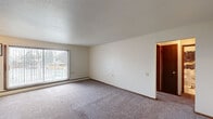 Located at 135 E 59th St in Minneapolis, MN, this single-floor unit offers a practical and comfortable layout designed for everyday living. The interior is finished with wall-to-wall carpet throughout the living and sleeping areas, providing a warm, understated feel, while the kitchen and bathroom feature easy-care hard flooring.

The living area is generously sized, featuring large windows dressed with vertical blinds that invite natural light and offer outdoor views. A ceiling fan with a light fixture provides both airflow and ambient lighting. Baseboard heating runs along the perimeter, ensuring efficient warmth throughout the colder Minneapolis months.

The kitchen is equipped with warm-toned wood cabinetry, dark countertops, a double sink, and white appliances including a refrigerator and stove. A textured ceiling adds visual character to the space.

The bedroom is well-proportioned with its own ceiling fan, a large window, and notable closet storage — featuring two side-by-side bi-fold closets offering ample hanging and shelving space.

The bathroom includes a vanity with dark wood cabinetry, a white countertop, tile flooring, and a shower-tub combination. Rich wood-toned door trim adds warmth and continuity throughout the unit's interior finishes.