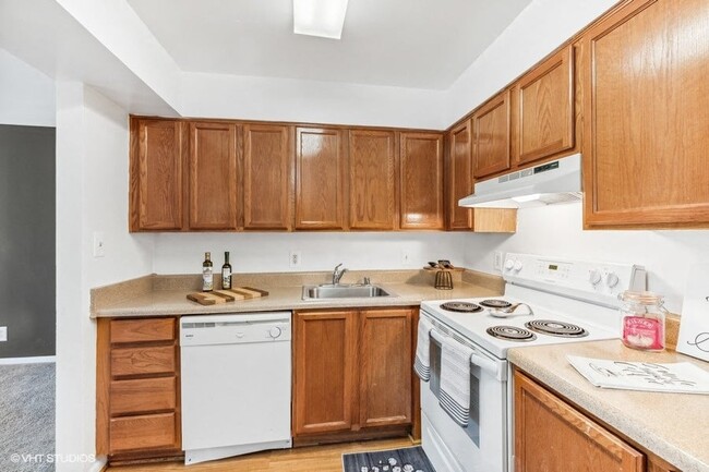 Fully Equipped Kitchen with White Appliances - The Pentacle Group Apartments