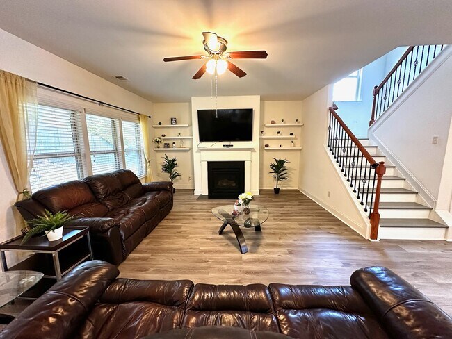 Relaxed Family Room with reclining leather couches, fireplace and mounted TV - 11242 Gates Ter