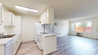 Located at Gramercy Drive in San Diego, CA 92123, this single-floor residence offers a bright, functional layout designed for comfortable everyday living. The open-concept living and dining area is finished with light wood-style vinyl flooring that extends throughout the main living spaces, creating a cohesive and airy feel. Natural light flows in through large windows fitted with vertical blinds, lending the space a welcoming ambiance.

The kitchen is positioned at the heart of the home and features a peninsula with a smooth countertop surface, white cabinetry with ample storage, an electric range, a refrigerator, a dishwasher, and an overhead range hood. The layout allows for easy interaction between the kitchen and the adjoining living area.

The bedrooms are carpeted for warmth and comfort, each receiving generous natural light through sizable windows. Closet space is provided in the bedrooms, including a built-in shelf unit. The textured ceilings are consistent throughout the unit.

The bathroom is clean and well-appointed, featuring a white vanity with a single sink, a large mirror with medicine cabinet, and a full shower-tub combination. Wood-style flooring continues into the bathroom, maintaining a unified design aesthetic across the home.