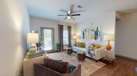 Located at 726 Cumberland Trace Rd in Bowling Green, Kentucky, this single-floor residence offers a thoughtfully designed open-concept layout with modern finishes throughout. The living area is bright and welcoming, featuring warm hardwood-style flooring, a ceiling fan, and direct access to an outdoor patio through a glass door that invites natural light. The space is generously sized, accommodating multiple seating arrangements with ease.

The kitchen is a standout feature, showcasing granite countertops, a large center island with bar seating, grey shaker-style cabinetry, a subway tile backsplash, and a full suite of stainless steel appliances, including a French door refrigerator, range, and built-in microwave.

The bedrooms are carpeted and comfortably proportioned, each offering ample room for full bedroom furnishings and natural light through well-dressed windows. Both bathrooms mirror the kitchen's refined aesthetic, with granite-topped grey vanities, hardwood-style flooring, and direct access to dedicated walk-in closets, providing excellent storage solutions.

Throughout the residence, a consistent design language of neutral tones, grey doors and trim, and quality finishes creates a cohesive and contemporary ambiance, making this Bowling Green home both functional and stylish.