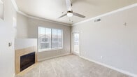 Located at 8092 W Paradise Ln in Peoria, Arizona, this one-bedroom, one-bathroom residence offers a well-designed single-floor layout that makes efficient use of its space. The open-concept kitchen and living area forms the heart of the home, anchored by a tiled corner fireplace and a ceiling fan that contribute to a comfortable, airy ambiance. Large windows invite abundant natural light throughout, with views of the surrounding neighborhood.

The kitchen is well-appointed with rich dark wood cabinetry, white quartz countertops, a subway tile backsplash, and a full suite of stainless steel appliances including a refrigerator, range, microwave, and dishwasher. A peninsula with pendant lighting connects the kitchen to the living area and provides additional workspace and seating.

The bedroom is carpeted and generously proportioned, featuring a ceiling fan and a dedicated closet. Soft neutral tones on the walls carry throughout all rooms, lending a clean and cohesive aesthetic. The bathroom includes a full tub-shower combination with wood-look vinyl flooring and dark wood cabinetry for added storage.

Additional features include an in-unit laundry area, a hallway for added privacy between rooms, and a private patio that extends the living space outdoors—ideal for enjoying the Arizona climate.