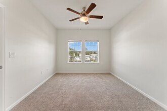 Bedroom 1 with ceiling fan, large double windows - Surf Apartments