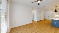 Located at 410 Walker Springs Rd in Knoxville, TN, this well-appointed 2-bedroom, 2-bathroom single-floor residence offers a thoughtfully designed open-concept layout. The kitchen is a standout feature, showcasing white shaker-style cabinetry, a white tile backsplash, stainless steel appliances including a French door refrigerator, electric range, and microwave, as well as a central island with a white quartz countertop and stylish pendant lighting — all flowing seamlessly into the living area. Light wood-style flooring runs throughout the home, complementing the clean, neutral palette. The spacious primary bedroom features a ceiling fan with light, a private balcony accessible through glass-paned doors, and a well-organized walk-in closet with built-in shelving and chrome rods. The primary bathroom offers a vanity with quartz countertops, a soaking tub, a tiled shower, and direct access to the walk-in closet. The second bedroom is equally bright, with a ceiling fan and a large window that invites natural light. A second walk-in closet and an additional full bathroom serve the space. A dedicated laundry room houses a full-size washer and dryer with overhead shelving, adding everyday convenience to this modern Knoxville residence.