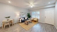 This 870 square foot single-story home in Wylie, Texas offers a thoughtfully designed layout with 2 bedrooms and 1 bathroom. The primary bedroom, measuring 150 square feet, provides a spacious retreat. The home's open-concept design seamlessly integrates the kitchen and living areas, creating an inviting space for both relaxation and entertainment.

The kitchen boasts modern dark wood cabinetry, granite countertops, and stainless steel appliances, including a side-by-side refrigerator. A convenient breakfast bar with seating for two adds functionality to the space. The living room features large windows that flood the area with natural light, while ceiling fans throughout ensure comfort.

The bathroom showcases a clean, contemporary design with a white tiled shower/tub combo and a dark wood vanity. Both bedrooms offer ample space and natural light, with the primary bedroom featuring an en-suite bathroom and closet.

Additional amenities include a separate laundry room with full-sized appliances, wood-look flooring throughout, and neutral paint colors that create a cohesive, modern aesthetic. The home's efficient layout maximizes every square foot, making it an ideal choice for those seeking a stylish and low-maintenance living space in Wylie.