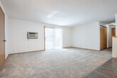 Located at 5097 N 28th Ave in Wausau, Wisconsin, this single-floor, 2-bedroom, 1-bathroom home offers a practical and comfortable layout. The open-concept living and dining area is bright and inviting, featuring soft carpet, a decorative chandelier, and a sliding glass door with vertical blinds that fills the space with natural light and provides outdoor access. A wall-mounted AC unit adds convenience to the living area.

The kitchen flows seamlessly from the dining space and is outfitted with warm oak cabinetry, a full suite of white appliances including a refrigerator, electric range, microwave, and dishwasher, as well as durable hardwood-style flooring and a closet pantry for added storage.

The primary bedroom is generously sized, featuring plush carpeting and a walk-in closet with built-in shelving and hanging rods. The second bedroom also offers carpet flooring, a bright window with neighborhood views, and closet access. Throughout the home, five closets provide exceptional storage options.

The full bathroom includes a tub/shower combination, a wood-toned vanity with a white countertop, and hardwood-style tile flooring. A dedicated laundry area and entrance complete this well-organized, single-level home.