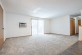 Located at 5097 N 28th Ave in Wausau, Wisconsin, this single-floor, 2-bedroom, 1-bathroom home offers a practical and comfortable layout. The open-concept living and dining area is bright and inviting, featuring soft carpet, a decorative chandelier, and a sliding glass door with vertical blinds that fills the space with natural light and provides outdoor access. A wall-mounted AC unit adds convenience to the living area.

The kitchen flows seamlessly from the dining space and is outfitted with warm oak cabinetry, a full suite of white appliances including a refrigerator, electric range, microwave, and dishwasher, as well as durable hardwood-style flooring and a closet pantry for added storage.

The primary bedroom is generously sized, featuring plush carpeting and a walk-in closet with built-in shelving and hanging rods. The second bedroom also offers carpet flooring, a bright window with neighborhood views, and closet access. Throughout the home, five closets provide exceptional storage options.

The full bathroom includes a tub/shower combination, a wood-toned vanity with a white countertop, and hardwood-style tile flooring. A dedicated laundry area and entrance complete this well-organized, single-level home.