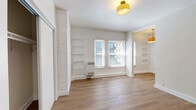 Located at 260 S Mariposa Ave in the heart of Los Angeles, CA 90004, this single-floor unit blends classic character with modern updates throughout. The living area is a standout, featuring whitewashed exposed brick walls that add texture and warmth, complemented by light hardwood-style flooring that runs consistently throughout the space. Built-in shelving units flank the room, offering both functional storage and architectural interest, while natural light pours in through double windows dressed with clean white blinds. Gold-toned flush-mount and pendant light fixtures add a stylish, cohesive touch to each room. The kitchen is efficiently designed with white shaker cabinetry, a warm butcher block countertop, a subway tile backsplash, and stainless steel appliances including a gas range, microwave, and refrigerator. The bedroom provides a comfortable retreat with its own window for natural light, a wall of whitewashed brick, and a spacious sliding-door closet. An entry area offers additional closet space for convenience. The bathroom is finished with a full soaking tub and shower, chrome fixtures, and striking black-and-white geometric patterned floor tiles that add a bold design element. Throughout, the unit maintains a bright, airy ambiance with a cohesive neutral palette.