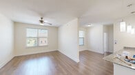 Located at 3449 Bobtown Rd in Garland, TX, this well-appointed 1-bedroom, 1-bathroom residence offers a thoughtfully designed single-floor layout. The open living room features warm hardwood-style flooring, a ceiling fan, and multiple windows fitted with blinds that invite natural light and provide views of the surrounding neighborhood. The kitchen is a standout feature, boasting granite countertops, dark cabinetry, stainless steel appliances including a refrigerator, range, and microwave, and stylish pendant lighting that hangs above the generous counter space. A stainless steel undermount sink completes the functional yet elegant cooking space. The bedroom is carpeted for comfort and benefits from natural light through a window with blinds. It includes direct access to a walk-in closet equipped with multi-tiered wire shelving, offering ample storage. The hallway leads to a well-finished bathroom featuring dark navy cabinetry, granite countertops, and a well-lit vanity mirror. Throughout the residence, crisp white walls and clean trim work contribute to a bright, cohesive aesthetic, creating a comfortable and modern living environment.