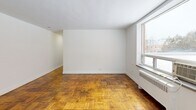 Located at 1065 Eglinton Ave W in Toronto's vibrant Forest Hill South neighbourhood, this 2-bedroom, 1-bathroom unit offers a practical and well-laid-out single-floor plan. A long entry hallway with classic parquet hardwood flooring sets the tone as you enter, leading into the main living areas.

The combined kitchen and living room provides a functional open layout. The kitchen features white cabinetry, a stainless steel stove, and ample storage, while the adjoining living area benefits from a large window that brings in natural light and offers views of the surrounding neighbourhood.

Both bedrooms continue the parquet hardwood flooring found throughout the unit. The primary bedroom is a cozy, well-defined space, while the second bedroom offers flexibility for use as a guest room or home office. Crisp white walls and clean lines keep the rooms feeling bright and airy.

The bathroom is finished with neutral beige tile work surrounding a full soaking tub with an overhead shower. A frosted window allows for natural light while maintaining privacy.

Throughout the unit, the warm-toned parquet hardwood floors provide a distinctive and timeless character, complemented by white baseboards and clean, simple finishes. The layout is efficient and thoughtfully organized, making the most of the available space.