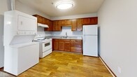 Located at 816 E Old Hickory Blvd in Nashville, Tennessee, this single-floor unit offers a practical and straightforward layout designed for comfortable everyday living. The kitchen serves as a functional hub, featuring warm wood-toned cabinetry arranged in an L-shaped configuration with ample storage, light-toned countertops, a stainless sink, and white appliances including an electric range and refrigerator. Notably, an in-unit washer is also accommodated within the kitchen area, adding a convenient laundry solution. Wood-look flooring runs throughout the kitchen, lending warmth to the space.

The living area transitions to soft carpeting, providing a comfortable, quiet atmosphere. Two bedrooms, each finished with neutral carpet and light gray walls, feature windows with blinds that allow natural light to filter in while maintaining privacy. Rich wood baseboards throughout add a consistent, polished detail.

The bathroom is well-appointed with wood-look flooring, a full tub-shower combination, a wood-vanity with a light countertop, a lighted mirror, and neutral gray walls, creating a clean and functional space. Overall, the unit presents a cohesive, move-in ready environment with consistent finishes throughout.