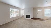 Located at 3001 N Texas St in Fairfield, CA, this 2-bedroom, 1-bathroom single-floor home offers a well-organized layout with a welcoming open-concept living and dining area. The living room is a standout, featuring a white-surround fireplace, large windows that bring in generous natural light, and soft carpeting underfoot. A front entry door with decorative glass panels adds a charming touch to the space.

The kitchen flows naturally from the living area and is equipped with dark espresso cabinetry, light stone-look countertops, black appliances including a range, microwave, dishwasher, and refrigerator, plus a ceiling fan overhead. Wood-look flooring in the kitchen transitions cleanly to carpet in the living spaces.

Both bedrooms are carpeted and bright, with large windows offering outdoor views of surrounding greenery. The primary bedroom includes a sliding glass door leading to a private outdoor patio area. The full bathroom features wood-look flooring, a wide vanity with a mirror, and a clean, bright finish throughout.

Additional conveniences include a dedicated laundry area, a closet for extra storage, and a layout that makes efficient use of every square foot. The neutral color palette throughout creates a calm, move-in-ready atmosphere.