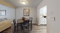 Located at 208 Jamil Rd in Columbia, South Carolina, this two-story home offers a well-organized layout across two levels, combining practical design with updated finishes throughout. The floor plan, visible in the dollhouse view, includes a staircase connecting the two floors and a thoughtful arrangement of living, dining, kitchen, and bedroom spaces.

The living room provides a comfortable gathering area finished with wood-look flooring and neutral gray walls, creating a versatile backdrop for various décor styles. Adjacent to the living room, the dining area flows seamlessly into the kitchen, which features white cabinetry, granite-style countertops, a stainless steel double-basin sink, and a window that allows natural light to brighten the workspace.

The bathrooms are well-appointed with granite-style vanity countertops, white cabinetry, and wood-look flooring. One bathroom includes a tiled tub-and-shower combination, while another features a separate shower area, offering added convenience.

The bedrooms are carpeted for comfort and include windows with blinds that provide natural light and privacy. The primary bedroom is generously proportioned, while the secondary bedroom comfortably accommodates multiple beds. Textured ceilings are consistent throughout the home, contributing to its classic residential character.