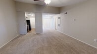 This 790 square foot apartment offers a comfortable living space with two bedrooms and one bathroom. The layout is efficiently designed to maximize the available space. Upon entering, you're greeted by a spacious living room featuring a cozy fireplace, perfect for relaxation. The room is enhanced by a ceiling fan and large windows that allow natural light to fill the space.

Throughout the apartment, neutral-toned walls and plush carpeting create a warm, inviting atmosphere. The kitchen, while not shown in detail, appears to be connected to the living area, promoting an open-concept feel. The bathroom showcases modern fixtures, including a white tub-shower combination and a single vanity.

Both bedrooms are carpeted and equipped with ceiling fans for comfort. The primary bedroom measures 140 square feet, providing ample space for a full-sized bed and additional furniture. Closet space is available in both bedrooms, with sliding doors for easy access.

The apartment's design incorporates practical elements such as central heating and air conditioning vents, ensuring year-round comfort. While the space is compact, the layout appears to be well-thought-out, offering a comfortable living environment for individuals or small families.