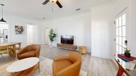This 1,290 square foot single-story home in Tampa, Florida offers a well-designed layout with three bedrooms and two bathrooms. The property features an open-concept living area that combines the living room and dining room, creating a spacious and inviting atmosphere. The kitchen is modern and functional, with white cabinetry, stainless steel appliances, and a window that allows natural light to flood in.

The primary bedroom, measuring 210 square feet, is generously sized and includes a ceiling fan and ample closet space. The other two bedrooms are well-proportioned and feature similar finishes. Both bathrooms are updated with contemporary fixtures and neutral color schemes.

Throughout the home, light-toned wood-look flooring adds warmth and continuity. Large windows in various rooms provide plenty of natural light and views of the surrounding area. The property also includes a garage for convenient parking and storage, as well as a dedicated laundry room with modern appliances.

The home's design emphasizes functionality and comfort, with clean lines and a neutral color palette that allows for personalization. Located at 2027 Villa Sites Dr in Tampa, this property offers a blend of modern amenities and practical living spaces, making it an attractive option for various lifestyles.