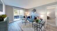 Located at 38 Westgate in Dover, New Hampshire, this single-floor residence offers a thoughtfully designed layout with a cohesive, modern aesthetic throughout. Soft gray walls and wood-look flooring flow through the main living areas, creating a calm and unified atmosphere.

The living room is a welcoming space anchored by large sliding glass doors that open to a private balcony, flooding the room with natural light and offering pleasant outdoor views of surrounding greenery. The kitchen features white shaker cabinetry with matte black hardware, light countertops, a stainless steel sink, and a full suite of stainless steel appliances, including a dishwasher, range, microwave, and refrigerator.

Adjacent to the kitchen, the dining area comfortably accommodates a full dining table and includes a convenient in-unit stacked washer and dryer tucked neatly into a closet. Multiple bedrooms are finished with plush carpet, ample natural light from well-placed windows, and closet storage. The bathroom is clean and bright, featuring wood-look tile flooring, a white vanity, and a tub-shower combination. The overall design is modern, functional, and move-in ready.