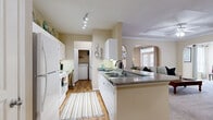 Located in the Harbor Cove community at 4630 Magnolia Cove Drive in Houston, TX, this well-appointed two-bedroom, two-bathroom residence offers comfortable single-floor living with a thoughtful layout and warm, neutral finishes throughout.

The kitchen is a functional centerpiece, featuring white cabinetry, granite-style countertops, a breakfast bar peninsula, and white appliances including a refrigerator and range. A double sink anchors the counter space, and the kitchen connects openly to the living and dining areas via a charming arched passageway. In-unit washer and dryer hookups are conveniently located just off the kitchen.

The dining room is bright and inviting, with large windows dressed in floor-length curtains that allow ample natural light. Crown molding and a chair rail add classic architectural detail to the space.

The living room features plush carpeting, crown molding, and an arched entryway that reinforces the home's cohesive design character. Both bedrooms are carpeted and offer generous proportions, with the primary bedroom providing a comfortable retreat complete with a ceiling fan and a walk-in closet featuring multi-tiered shelving. The bathrooms include a soaking tub with white tile surround. Warm beige tones, wood-look flooring in the kitchen, and carpet in living and sleeping areas create a consistent, welcoming ambiance throughout.