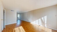 Located in Pasadena, TX, this two-story, 2-bedroom, 3-bathroom home offers a well-organized layout across two floors. The main level opens into a spacious living room highlighted by warm hardwood-style flooring, large floor-to-ceiling windows that flood the room with natural light, and a striking white brick fireplace as the centerpiece. The adjoining kitchen is thoughtfully designed with warm wood cabinetry, a central island with a light countertop, black appliances including a refrigerator, range, and dishwasher, and a window above the sink for added brightness. A closet with louvered doors provides convenient storage off the kitchen. The main level also includes a bathroom with a tiled tub-shower combination and hardwood-style flooring. Upstairs, two carpeted bedrooms offer comfortable retreats, each benefiting from natural light. The primary bedroom is generously sized, while the second bedroom features a ceiling fan and a window with neighborhood views. Both bedrooms are complemented by closets and access to well-appointed bathrooms, including one with a wood-toned vanity and granite-style countertop. A staircase and hallway connect the two levels, creating a cohesive and functional flow throughout this inviting home.