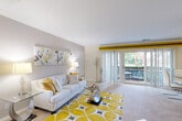 Located at 3308 Lockheed Blvd in Alexandria, Virginia, this two-bedroom, one-bathroom residence is thoughtfully laid out across a single floor. The bright and open living room features plush carpeting, smooth ceilings, and large sliding glass doors that flood the space with natural light and provide direct access to a private balcony overlooking lush greenery. A decorative beam accent marks the transition into the dining area, which sits adjacent to the kitchen and shares the same outdoor view through sliding glass doors. The kitchen is equipped with light wood cabinetry, dark granite countertops, a gas range, and tile flooring, offering a functional galley-style layout. The primary bedroom is generously sized, while the second bedroom provides a comfortable and versatile space, both featuring soft carpet and windows with natural light. Three closets throughout the unit provide ample storage. The full bathroom is finished in a clean, bright palette with tile flooring, a wood vanity, and a tub-shower combination. A dedicated utility room and hallway complete the floor plan. With its efficient layout and connection to the outdoors, this residence offers a comfortable and practical living environment in Alexandria.