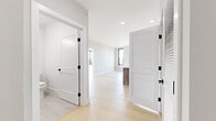 Located at 151 N Fifth St in Newark, NJ, this thoughtfully designed 2-bedroom, 1-bathroom unit offers a clean, contemporary aesthetic throughout its well-proportioned single-floor layout. Light-toned hardwood flooring flows seamlessly across every room, complementing the crisp white walls and creating a bright, cohesive atmosphere.

The open-concept kitchen is a standout feature, anchored by a substantial island with a white quartz countertop and warm wood cabinetry. Stainless steel appliances — including a refrigerator, electric range, and over-the-range microwave — add a modern, functional edge. A subway tile backsplash and recessed lighting complete the space, while a large black-framed window floods the area with natural light and frames outdoor views of the surrounding neighborhood.

The spacious primary bedroom benefits from generous proportions, a dedicated closet, and a large window that invites abundant sunlight and outdoor views. The second bedroom is equally well-lit, featuring its own closet and a floor-to-ceiling black-framed window with scenic treetop views. Both bedrooms include individual PTAC units for personalized climate control.

The bathroom is finished with elegant marble-style wall tiles surrounding a full soaking tub with chrome fixtures. A louvered closet door in the common area provides additional storage. Recessed lighting and matte black door hardware are consistent design details that unify the modern character of this well-appointed home.