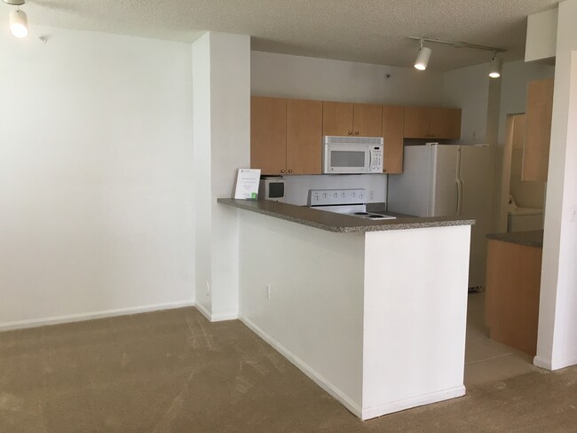 Building Photo - Great first floor corner unit, gated commu...